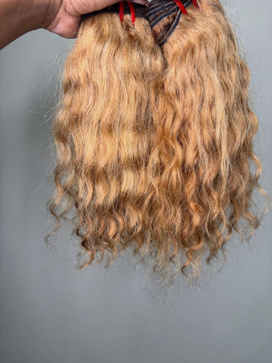 Honey blonde deep wave bundles held up by Bee